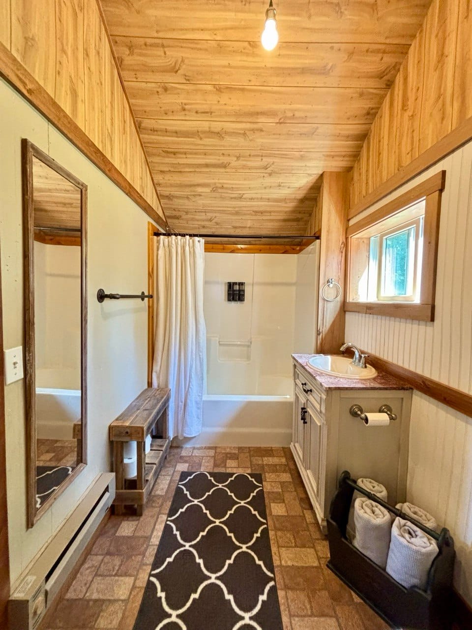 Bathroom with cathedral wood ceiling and a soaking tub